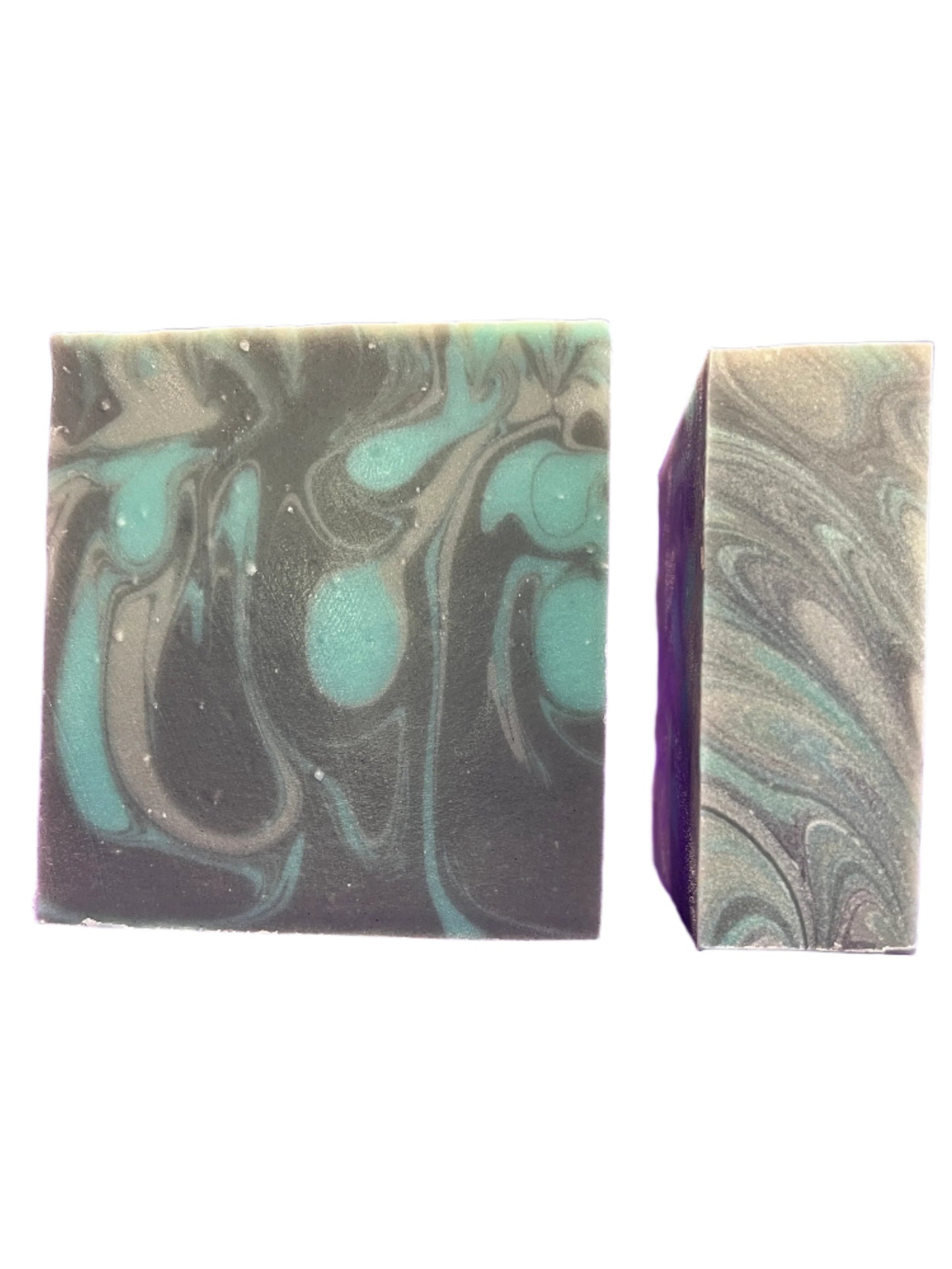Two marbled soap bars with teal and gray swirls on a white background