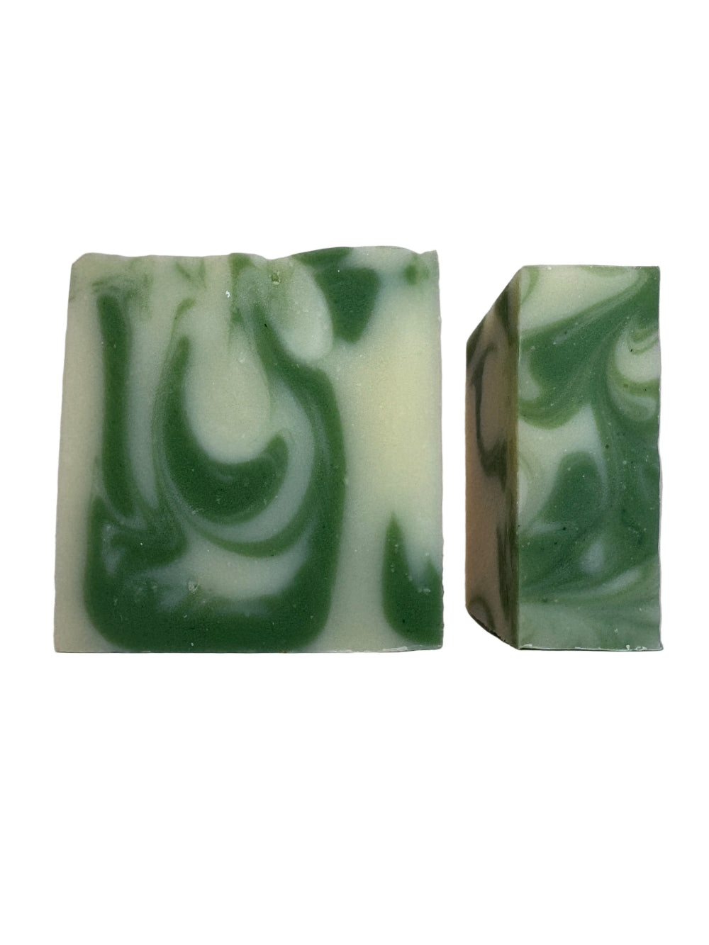 Two green and white marbled soap bars on a light gray background