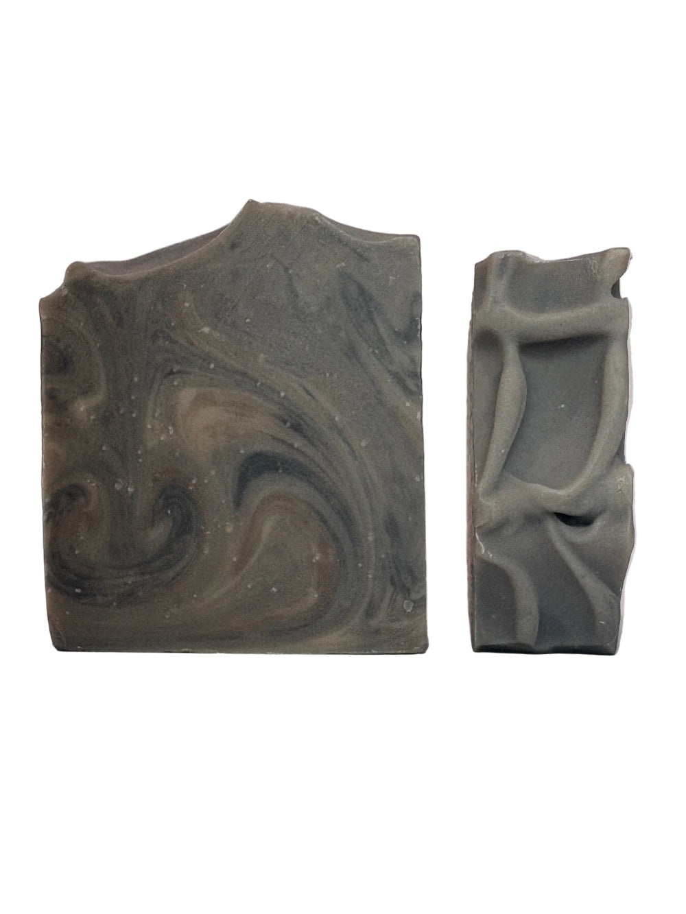 Two pieces of marbled soap on a white background