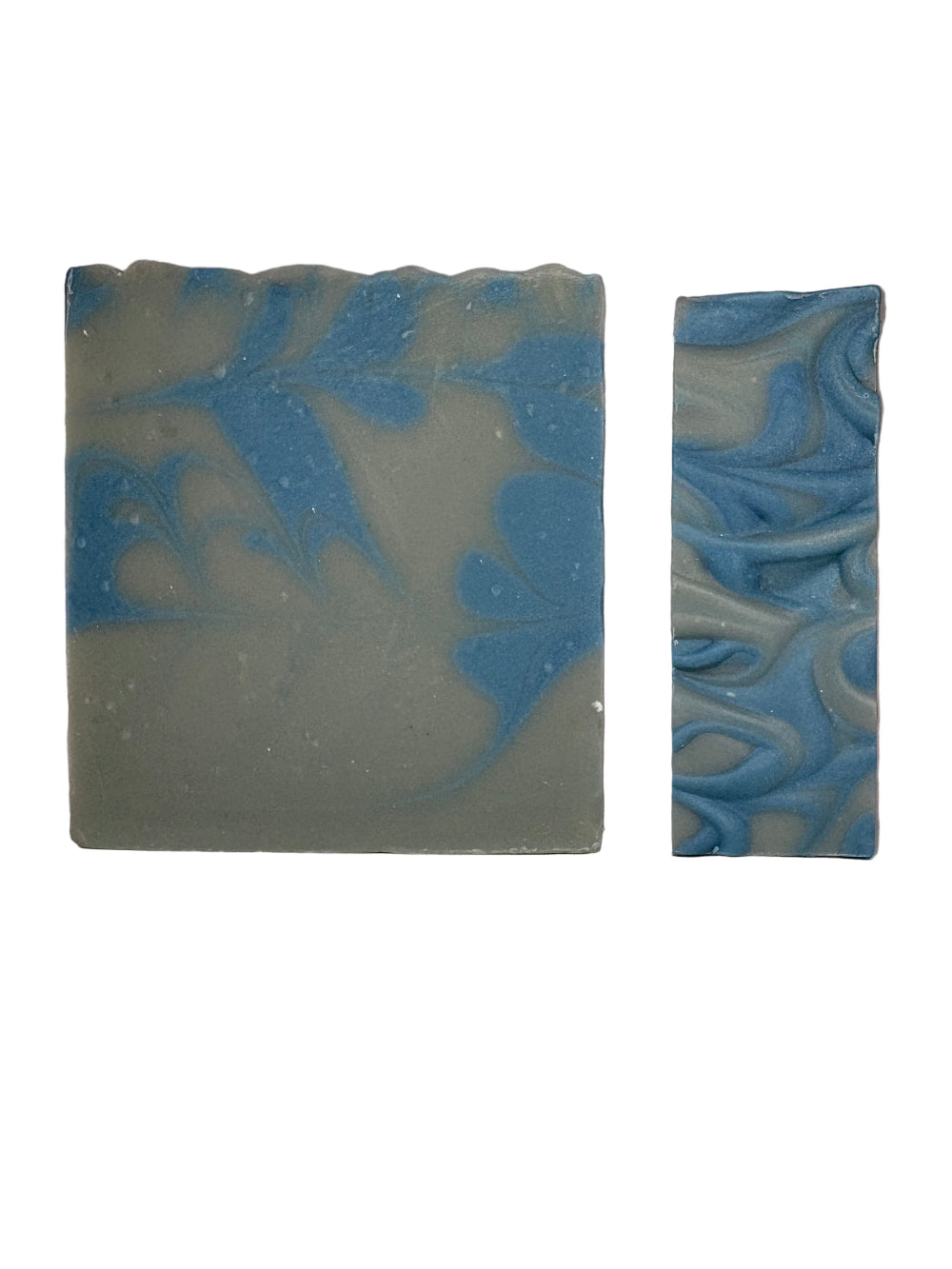 Two bars of soap with blue and grey marbled pattern on a white background
