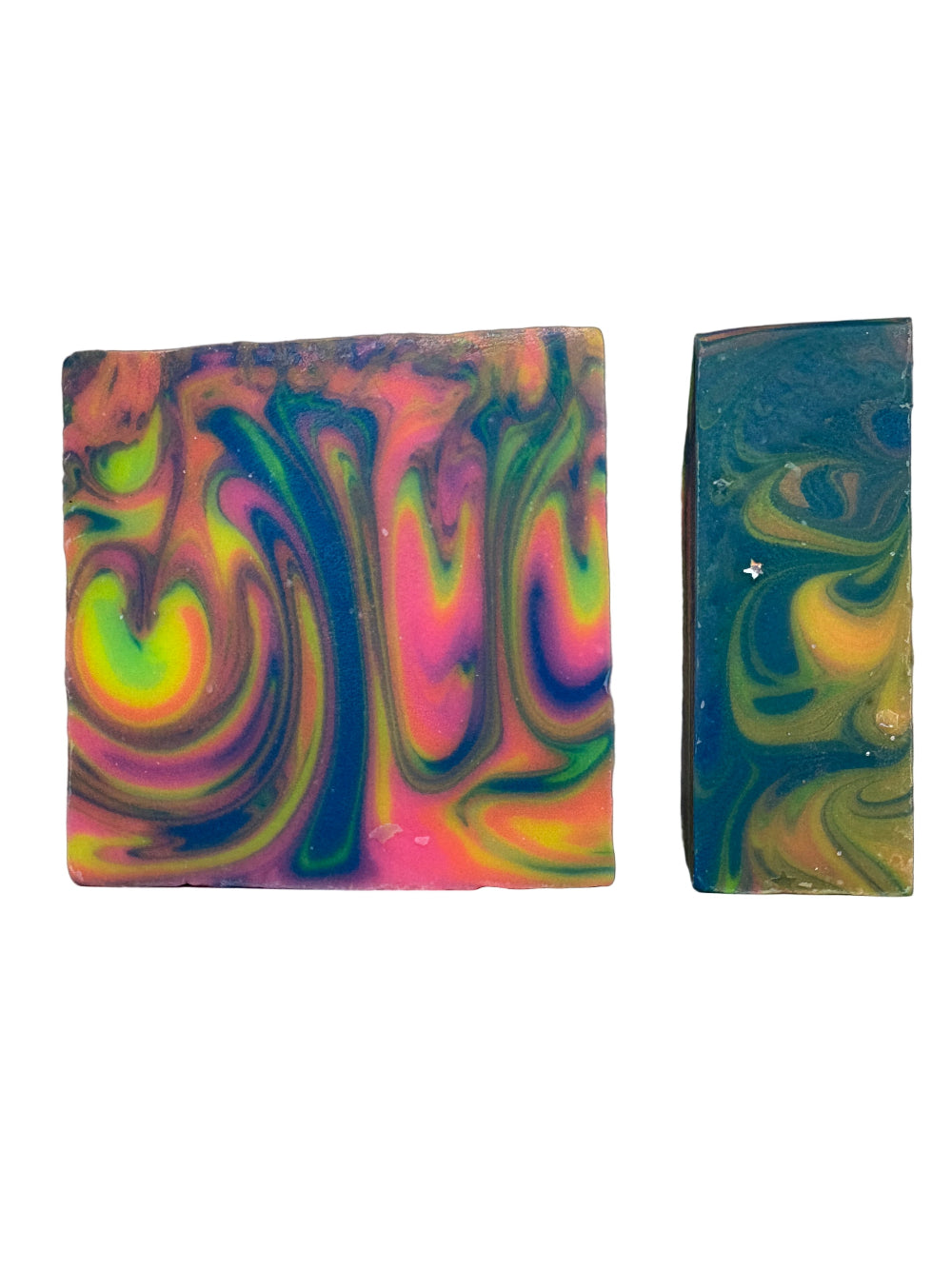 Two colorful rainbow sherbet soap bars with swirl patterns on a gray background