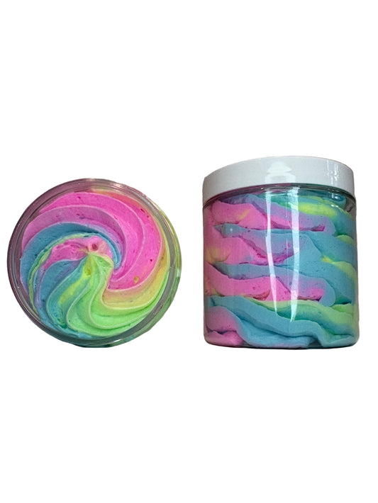 Two containers of whipped soap with colorful rainbow swirl patterns on a gray background