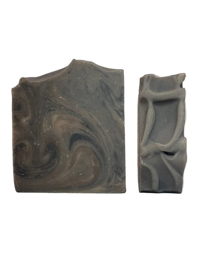 Two pieces of marbled soap on a white background